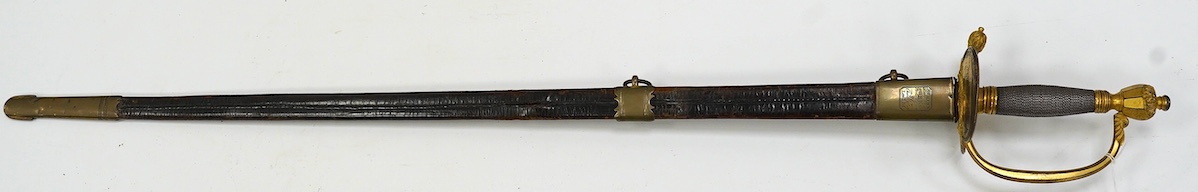 A 1796 pattern infantry officer's sword, blued and gilt blade, etched with crowned GR and Royal Arms, regulation gilt brass hilt, in its leather scabbard with brass mounts, locket signed S. Brunn, 81.5cm. Condition - goo